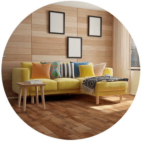 A yellow couch with colorful pillows in a living room.