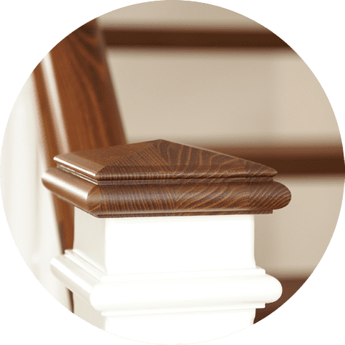 Close-up of a decorative wood staircase newel post.