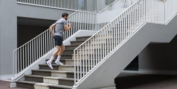Man running up modern outdoor stairs.